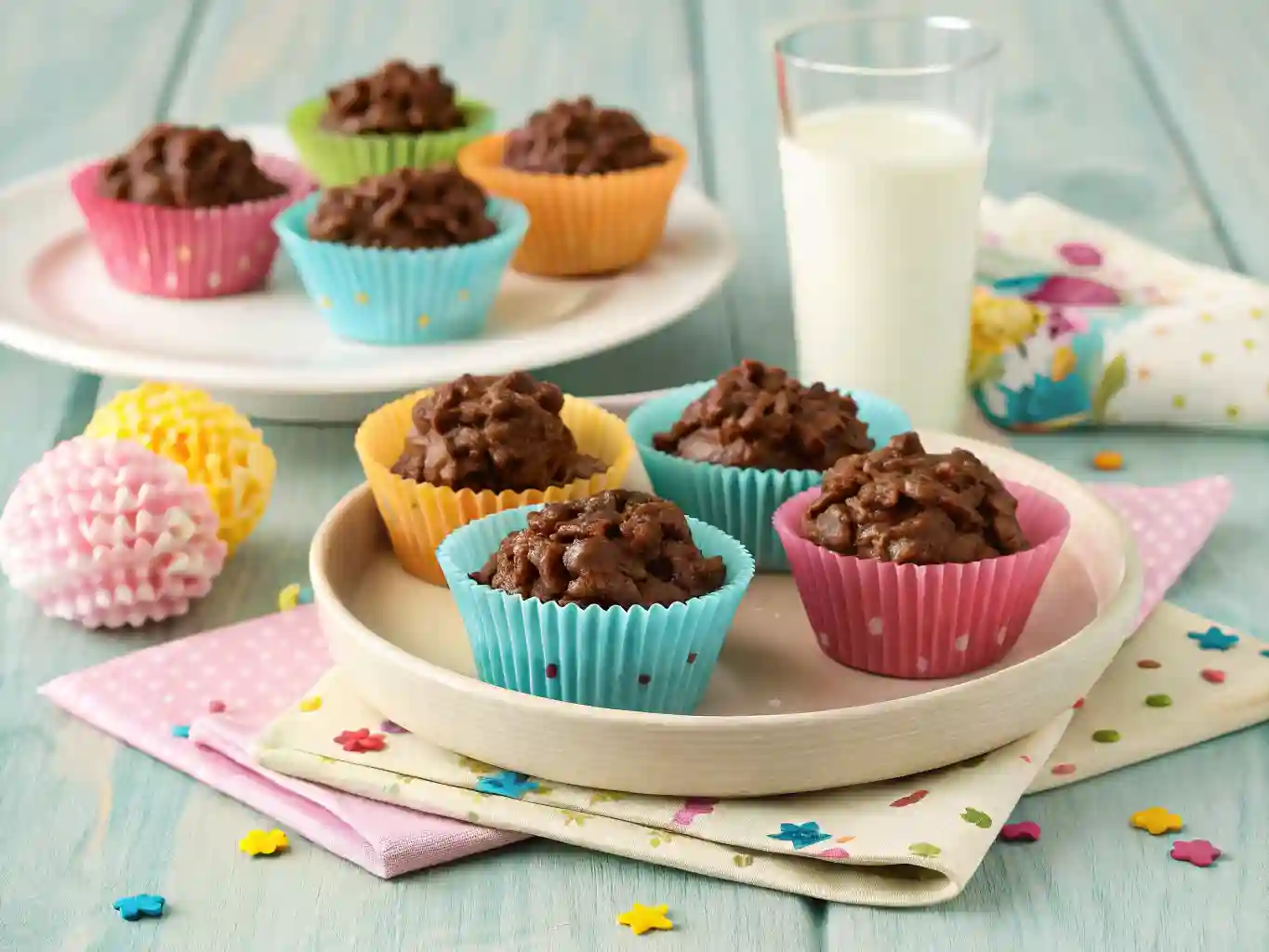 finished-chocolate-cornflake-cakes Chocolate cornflake cakes in vibrant paper wrappers served with a glass of milk