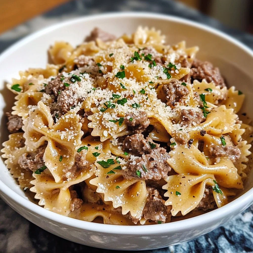 Creamy parmesan garlic beef bowtie pasta with herbs and spices